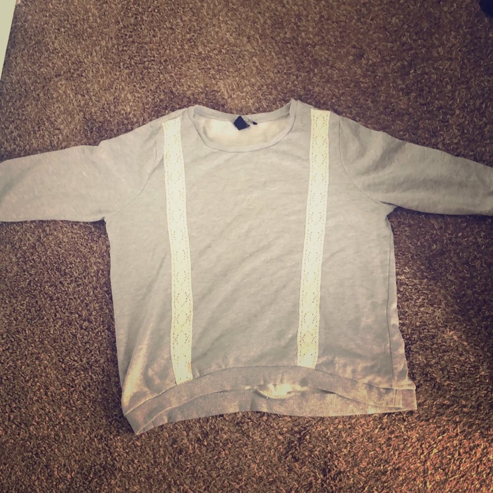 A long sleeve shirt that has lace on the front